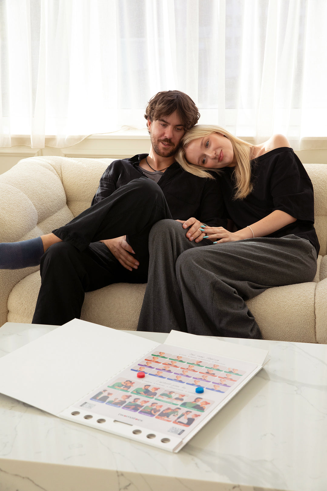 Couple sharing a supportive moment beside the Twomatoes Emotion Board attached to a pale oak wardrobe
